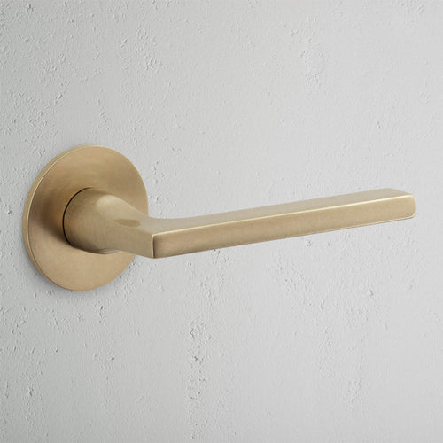 Clayton Sprung Door Handle With Flush Rose - Antique Brass
