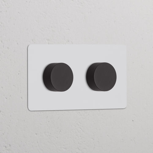 Double 2x Multiway Dimmer Switch – Paintable Bronze with two round knobs on a wall plate.